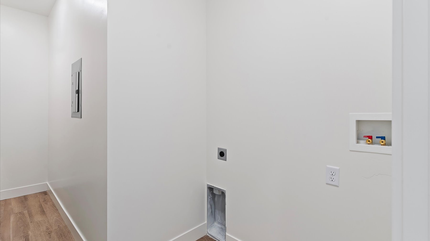 Laundry room featuring wood finished floors, washer hookup, electric dryer hookup, and electric panel