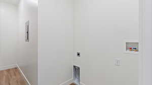 Laundry room featuring wood finished floors, washer hookup, electric dryer hookup, and electric panel