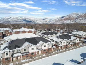 Snowy aerial view with a mountain view and a residential view