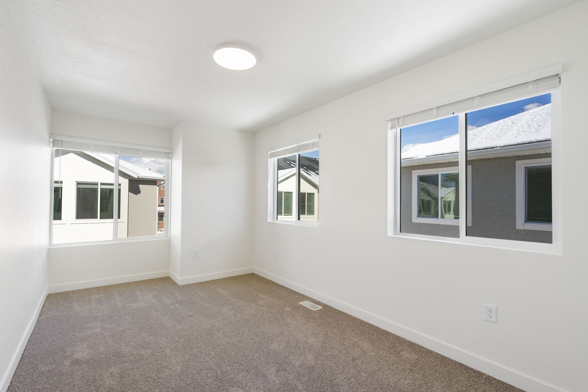 Carpeted spare room featuring baseboards
