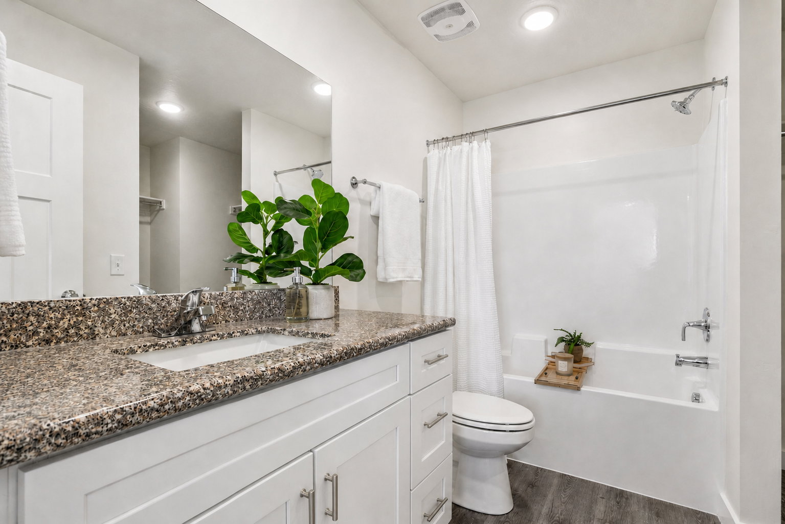 Bathroom with vanity, shower / tub combo, dark wood-type flooring, and recessed lighting