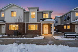 View of front of property with brick siding and board and batten siding