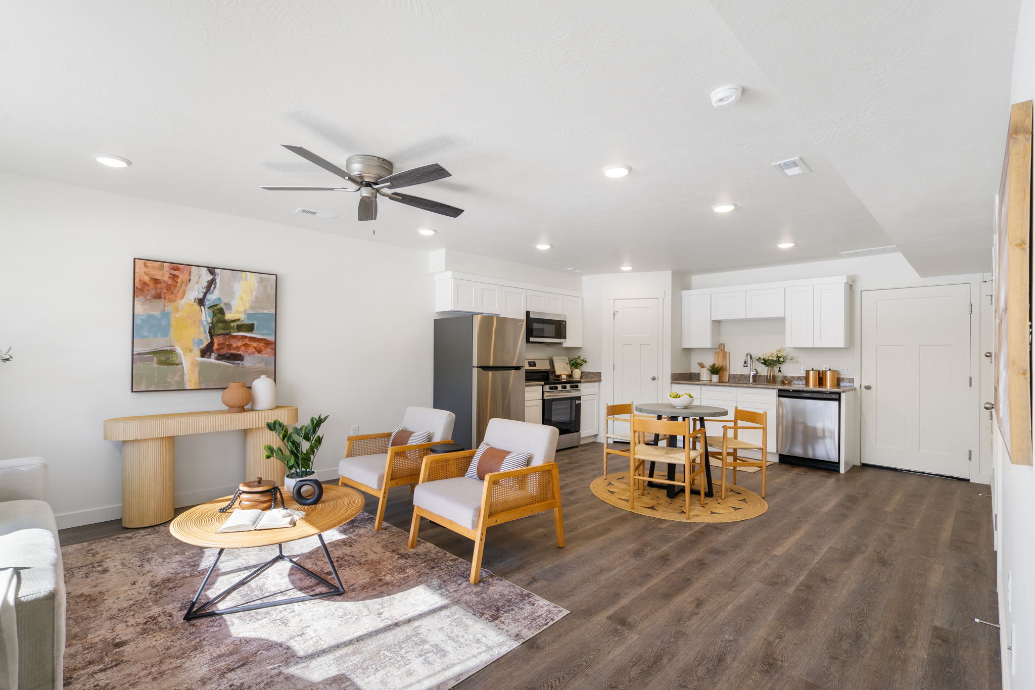 Living room with a ceiling fan, dark wood-type flooring, and recessed lighting