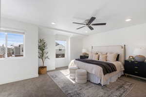 Carpeted bedroom featuring a ceiling fan and recessed lighting