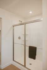 Bathroom featuring a stall shower, recessed lighting, and light wood-style flooring