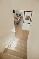 Stairway featuring wood finished floors and baseboards