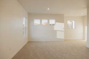 Spare room with light colored carpet and recessed lighting