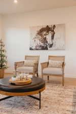 Sitting room with wood finished floors and recessed lighting