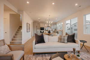 Living room with hanging lights and light wood-style floors