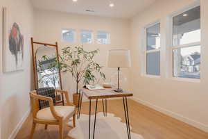 Home office with wood finished floors and recessed lighting