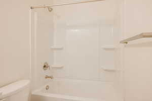 Bathroom with toilet and tub / shower combination