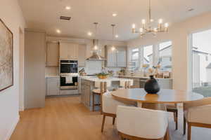 Dining room featuring light wood-type flooring and hanging lights