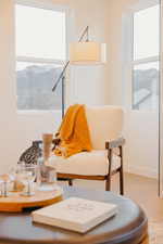 Living area with wood finished floors and baseboards