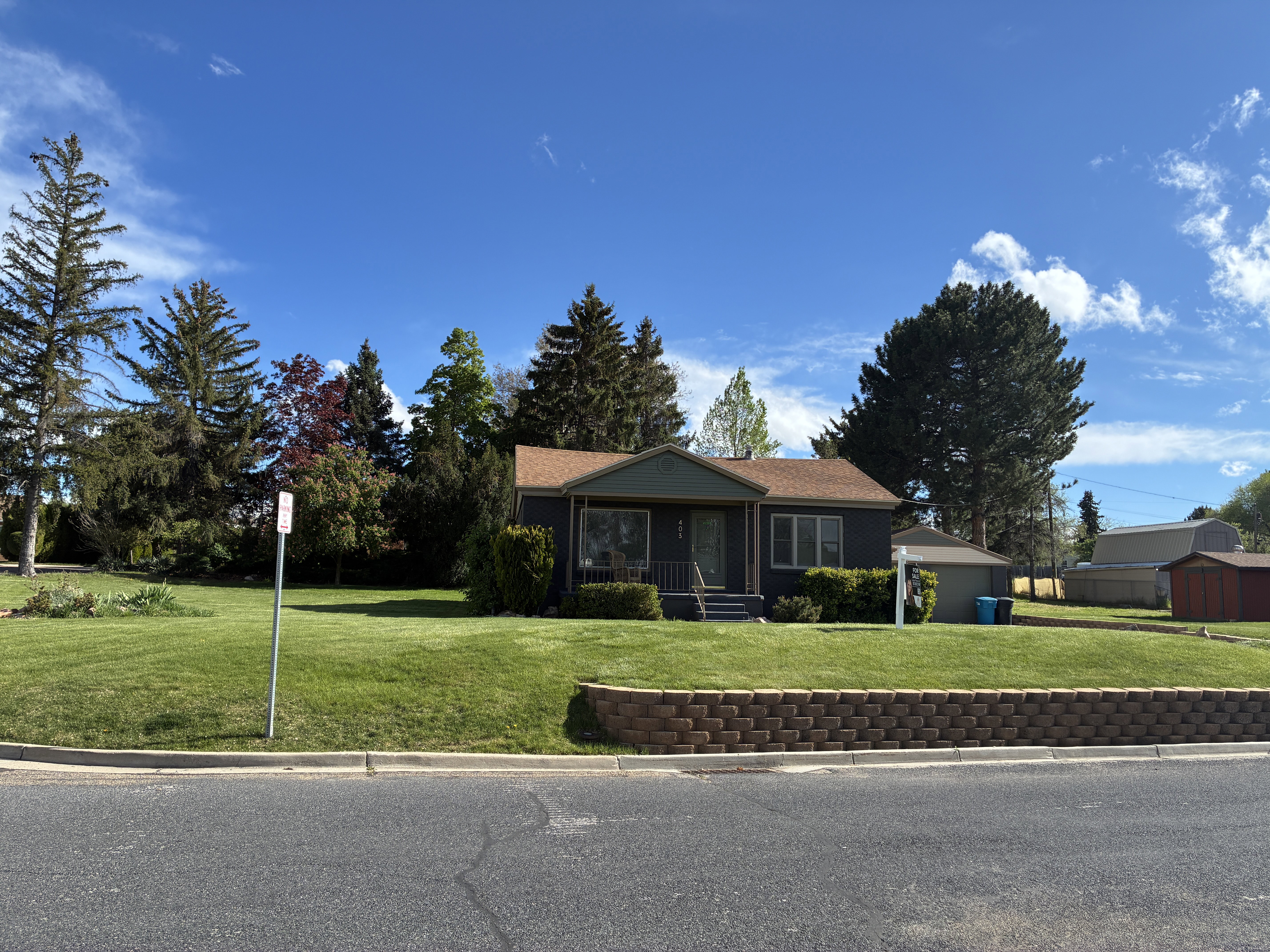 Single story home featuring a front lawn and a porch