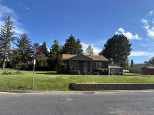 Single story home featuring a front lawn and a porch