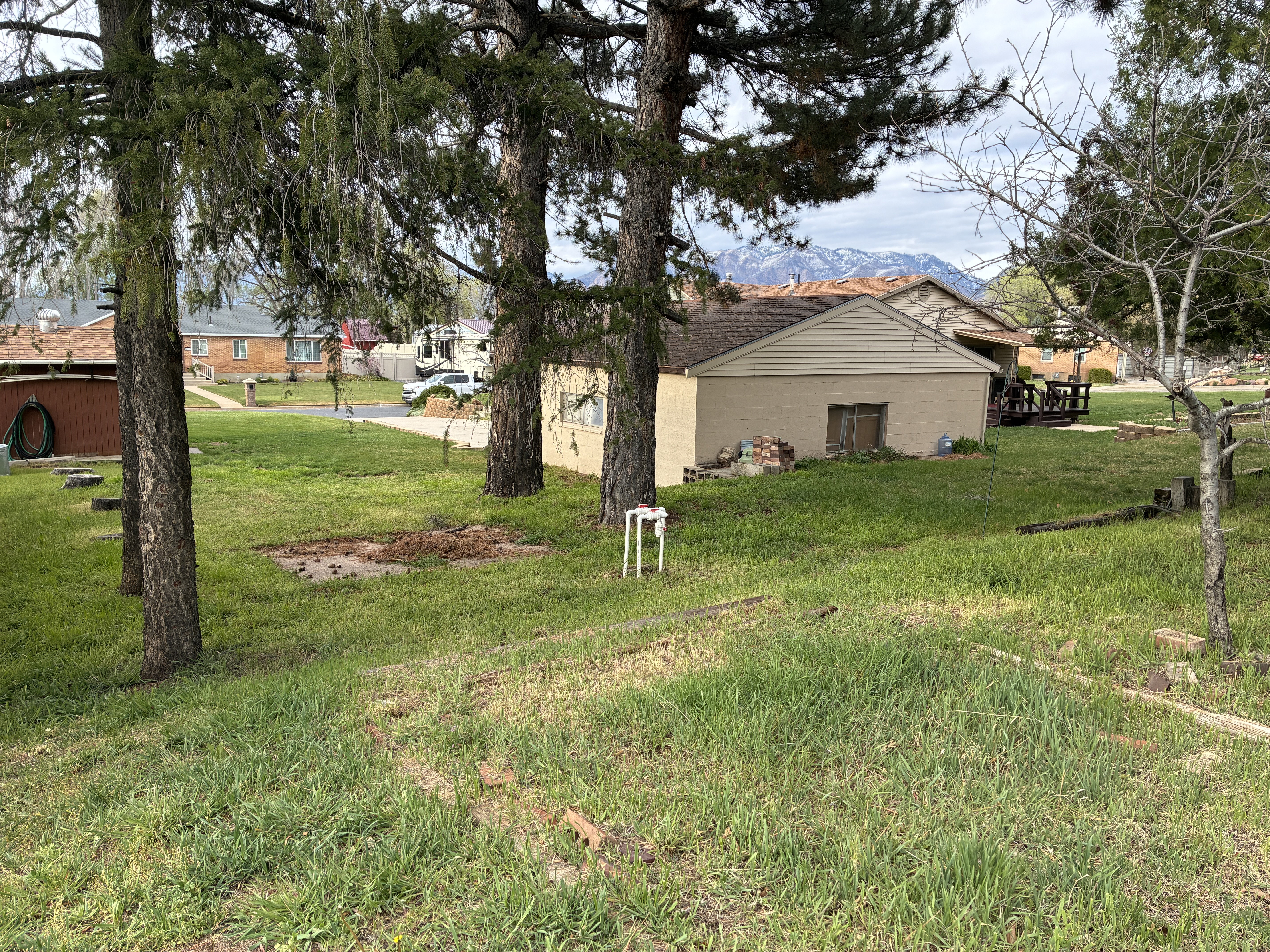 On the opposite side of the garage the lot extends out another 30 feet or so, there is a cement slab where you could store an RV, a side by side, 4-wheelers, or any of your toys. There are garden plots ready to go bordered with railraod ties.