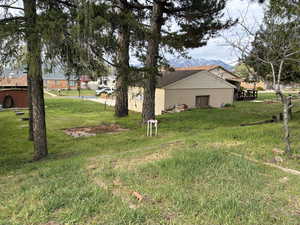 On the opposite side of the garage the lot extends out another 30 feet or so, there is a cement slab where you could store an RV, a side by side, 4-wheelers, or any of your toys. There are garden plots ready to go bordered with railraod ties.