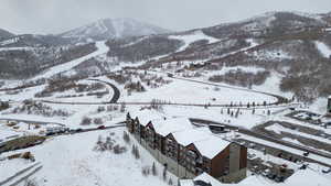 Snowy aerial view featuring a mountain view