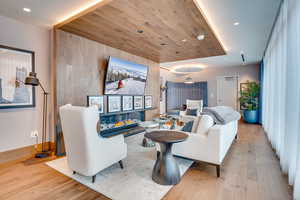 Living area featuring light wood-style flooring, recessed lighting, and wood ceiling
