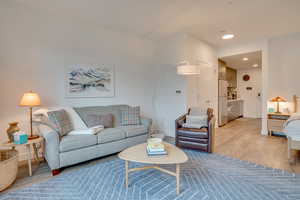 Living room featuring light wood-type flooring and recessed lighting