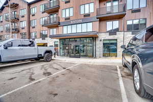 View of property featuring uncovered parking