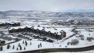 Snowy aerial view featuring a mountain view