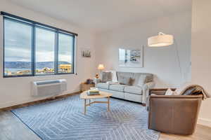 Living area with a mountain view and wood finished floors