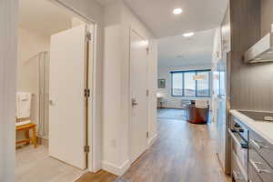 Hall featuring light wood-style flooring and recessed lighting