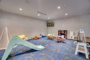 Recreation room featuring recessed lighting and carpet flooring