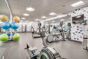 Workout area featuring a paneled ceiling