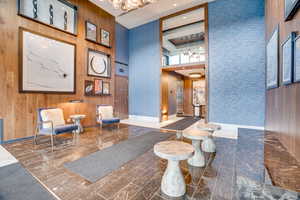 Common area with a high ceiling and wooden walls