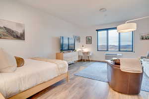 Bedroom featuring light wood-style flooring and baseboards