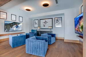 Cinema room with hardwood / wood-style floors and baseboards