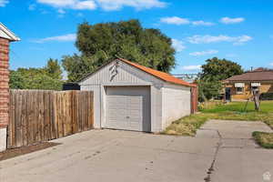 Detached garage featuring concrete driveway