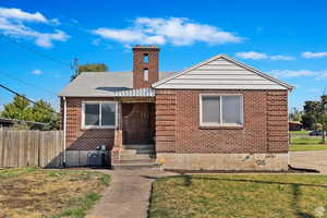 Bungalow featuring brick siding and entry steps