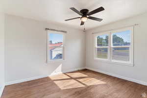 Empty room featuring light wood-style floors and ceiling fan