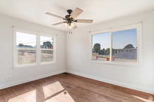 Unfurnished room featuring wood-type flooring and a ceiling fan