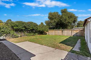 Fenced backyard with a patio area