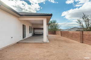 Fenced backyard with a patio
