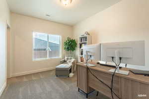 Office featuring baseboards and light carpet