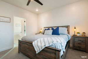 Bedroom featuring carpet floors, ceiling fan, and ensuite bathroom