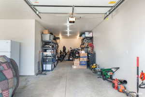 Garage featuring freestanding refrigerator