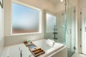 Bathroom with a bath and a stall shower