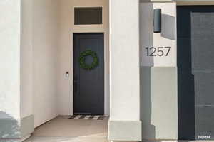 Entrance to property with stucco siding