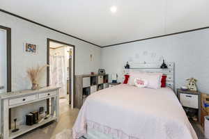 Bedroom featuring carpet, wallpapered walls, crown molding, and recessed lighting