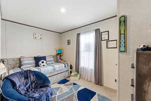 Bedroom featuring carpet flooring, ornamental molding, recessed lighting, and wallpapered walls