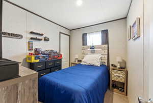 Bedroom featuring carpet flooring and ornamental molding