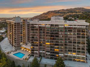 View of building exterior with a community pool and a mountain view