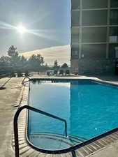 Pool at dusk with a community pool