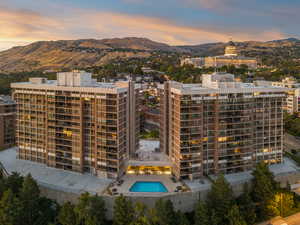 Property at dusk with a North mountain view towards State Capitol and Ensign Peak , a community pool.